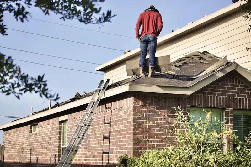Professional roofer working on a residential roof in West Enon Estates